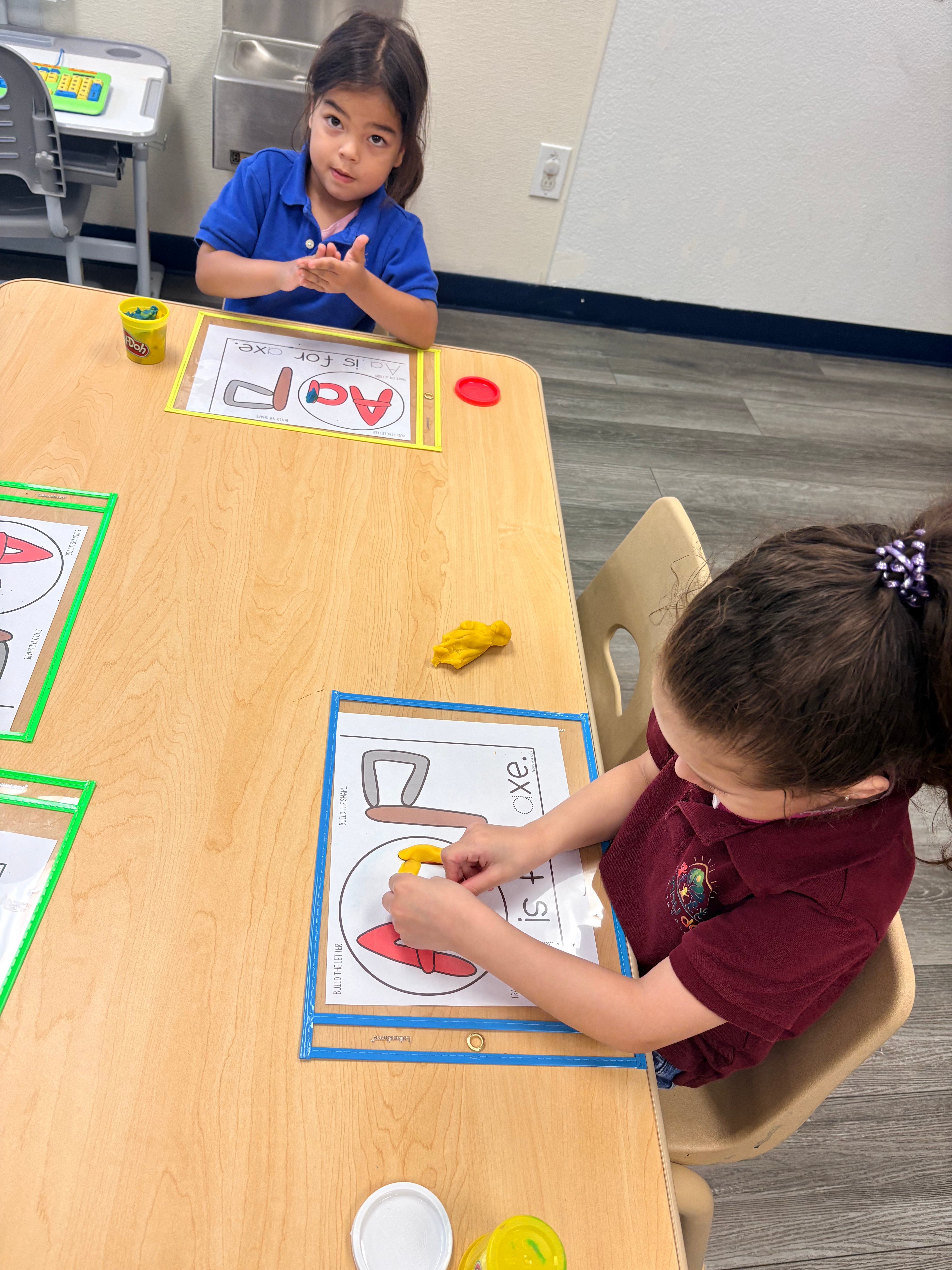 Children engaged in a colorful classroom activity at Sunny Day School